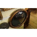 A 19th century gilt framed circular convex wall mirror, 58.5cm diameter.