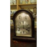 An early 20th century mahogany mantle clock, with silvered arch dial, 33cm high.