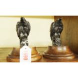 A pair of metal eagles, each on a beech wood socle base, total height 12cm.
