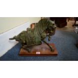 A Tang style bronze horse, 26cm high, on wood plinth.