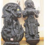 Two similar black painted papier mache relief plaques of Balinese figures, 58.5cm high.