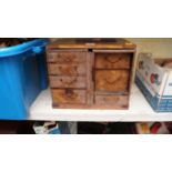 An early 20th century Japanese parquetry table cabinet, 32cm wide.