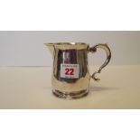 A silver milk jug.