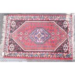 A small Shiraz rug having central medallion.