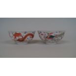 A pair of Chinese dragon and phoenix bowls, Qianlong six character marks, painted to the interior