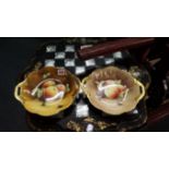 A pair of Coalport fruit painted twin handled dishes, by H Ridd and M Cooke, 25.5cm wide.