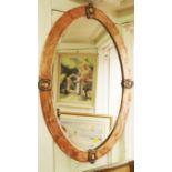 An Arts And Crafts hammered copper framed oval wall mirror, 81 x 55.5xm.