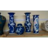 A pair of Chinese blue and white vases, 30.5cm high, (chips); together with a similar ginger jar and