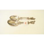 A pair of antique Dutch white metal figural serving spoons,