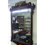 An antique mahogany and inlaid fret framed wall mirror, 110 x 70cm.