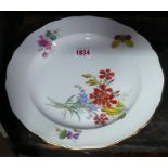 A Meissen plate, painted with a butterfly and flowers, 25.5cm diameter.