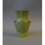 A Chinese carved and lime green glazed twin handled foliate vase, seal of Wang Bingrong,
