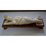 A Chinese carved ivory doctors' model, late 19th/early 20th century, 18.5cm long, on hardwood stand.