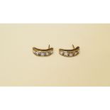 A pair of 18ct yellow gold and channel set aquamarine half hoop earrings.