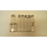 Eight various silver lidded glass jars.