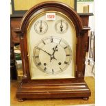 An early 20th century mahogany mantel clock, with silvered arched dial, 36.5cm high.