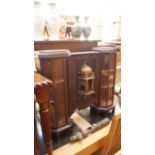 An unusual Eastern style carved oak cabinet, with glazed panel ends, 76cm wide.