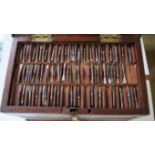 A miniature mahogany tool chest, enclosing five removable trays of miniature steel lathe tools,