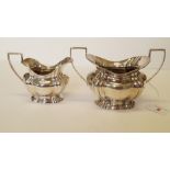 An Edwardian silver sugar bowl and matching creamer, by William Aitkin, Birmingham 1904, 253.