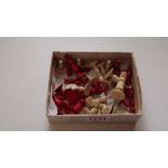 An antique bone chess set, red stained and natural, king 5cm, pawn 2.9cm.