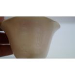 A Chinese blanc de chine tripod libation cup, incised with two columns of script, 10cm wide,