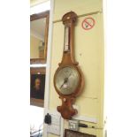 A Victorian mahogany wheel barometer, with 9.5in silvered circular dial.