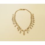 An early 20th century unmarked yellow metal fringe necklace,