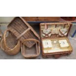 A vintage Coracle wicker picnic set; together with four other wicker baskets.