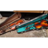 Four various violins, in cases.