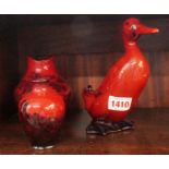 A Royal Doulton flambe duck, 16cm high; together with two Royal Doulton flambe vases.