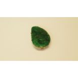 A Chinese unmarked yellow metal and carved jade clip.