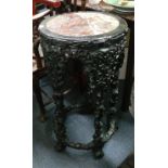 A Chinese carved and ebonized jardiniere stand, late 19th century, with marble inset top, 79.