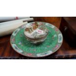 A Japanese Satsuma pottery circular dish and cover; together with a Chinese famille rose charger,