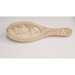 An Indian carved ivory hand mirror, late 19th century,
