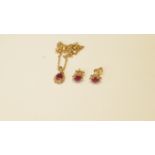 A 9ct gold necklace with ruby pendant and pair of matching ear studs.