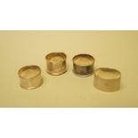 Four various silver napkin rings, 111g.