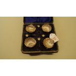 A cased set of four late Victorian silver shell shaped salts and spoons,