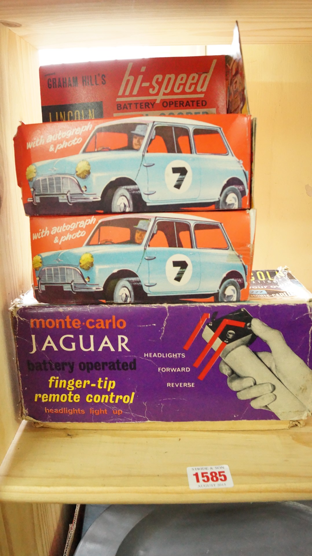 Three Lincoln International battery operated cars, comprising: Monte Carlo Jaguar; and two Mini