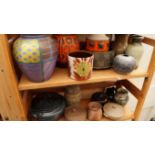 Studio Pottery: a mixed lot of bowls, chargers, vases and jars and covers, (three shelves).