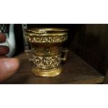 An old polished bronze twin handled mortar, inscribed around the frieze and bearing date 1590,