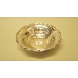 A German. 800 white metal circular dish, having scroll rim, stamped makers mark, 21.5cm diameter.