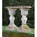 A pair of Victorian carved Cotswold stone basket planters on stands  circa 1870 117cm.; 46ins high