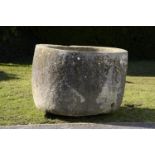 A carved stone cylindrical trough  71cm.; 28ins high by 100cm.; 39ins diameter