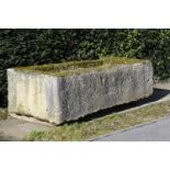 A particularly large carved limestone trough  70cm.; 27½ high by 236cm.; 93ins long by 110cm.; 43ins