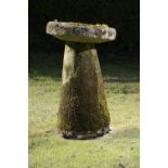 A staddlestone base incorporating an associated dished bird bath top    86cm.; 34ins high