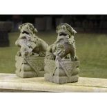 A pair of carved stone dogs of Fo    South-East Asian, 2nd half 20th century  48cm.; 19ins high