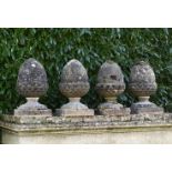 A pair of composition stone acorn finials    early 20th century  56cm.; 22ins high