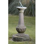 A Victorian carved stone sundial    late 19th century  with 11in bronze dial  117cm.; 46ins high