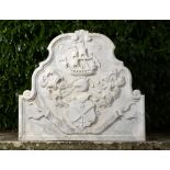 A Georgian carved marble arched armorial plaque    dated 1753  87cm.; 34ins high by 97cm.; 38ins