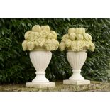 A pair of carved limestone fruit basket finials    last quarter 20th century  74cm.; 29ins high